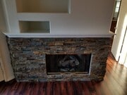 Stacked stone fireplace with gas fireplace insert - 16939 Robins Nest Way Unit 1