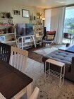 Open plan kitchen, dining, and living room with full-slide floor-to-ceiling doors leading to balcony - 4944 Cass St Condo Unit 706