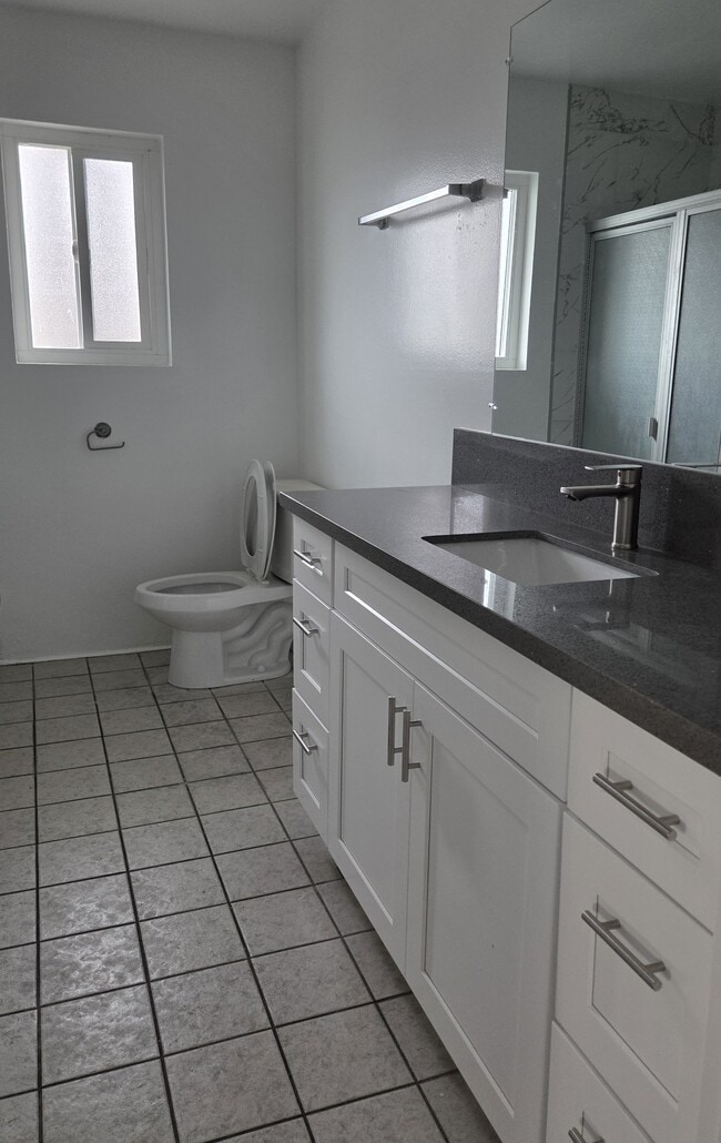 Hall bathroom with new cabinets and quartz countertops - 3455 Elm Ave Unit #215