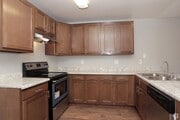 Kitchen with beautiful and spacious wood cabinets at Riverdale Apartment Homes in Hemet, California. - Riverdale Apartments