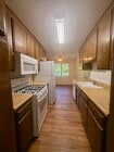 Kitchen W Fridge, Microwave, Stove, & dishwasher - 11819 Kiowa Ave Apartments