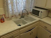 Kitchen counter top showing sink and lower cabinets - 5646 Farmdale Ave Apartment Unit 3/4