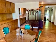 The front entry and kitchen lead into the dining room that looks onto the cascades of the backyard. - 11449 Woodbine St