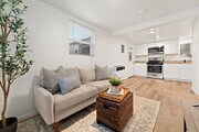 Living room, front door, kitchen - 4510 48th St Apartments Unit 1BR