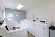 Community laundry room. Additionally, every individual private garage has their own washer and dryer hook up. - Corbin Terrace Apartments