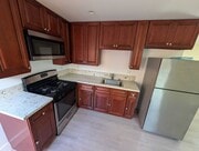 Kitchen with gas range, microwave, and ample cabinet storage - 6534 Peterson Ave