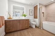 Beautiful bathroom with large tiled tub - AMLI Aero