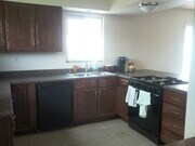 Hand Stained Cherry wood cabinets, dishwasher, garbage disposal and slide in stove - 400 East Airport Avenue