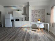 “Bright, modern full kitchen with induction cooktop, stainless hood, and spacious dining area. - 3058 Galloping Hills Rd Unit Harmony e