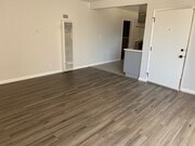 Large living area with wall heater and air conditioning - 1016 Western Ave Apartments Unit A