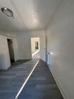 Primary bedroom with view to rest of apartment - 1929 Daly St Apartments Unit 1-2 One Half