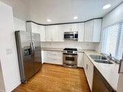Photo - Stunning 4BR Townhome with Hardwood Floors, Private Patio, Community Pool & 2-Car Garage!