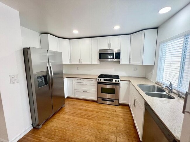 Photo - Stunning 4BR Townhome with Hardwood Floors, Private Patio, Community Pool & 2-Car Garage!
