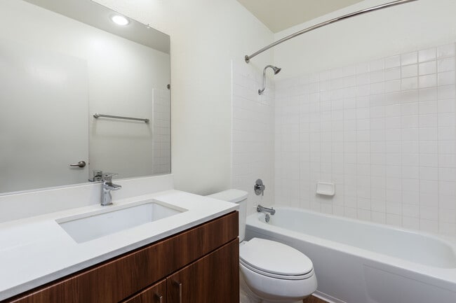 Renovated I bath with new cabinetry, quartz countertop, and hard surface flooring - eaves Huntington Beach