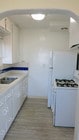 Kitchen-all white with dark blue accent. - 3607 Crest Dr Unit Lower