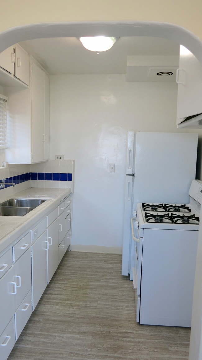 Kitchen-all white with dark blue accent. - 3607 Crest Dr Unit Lower