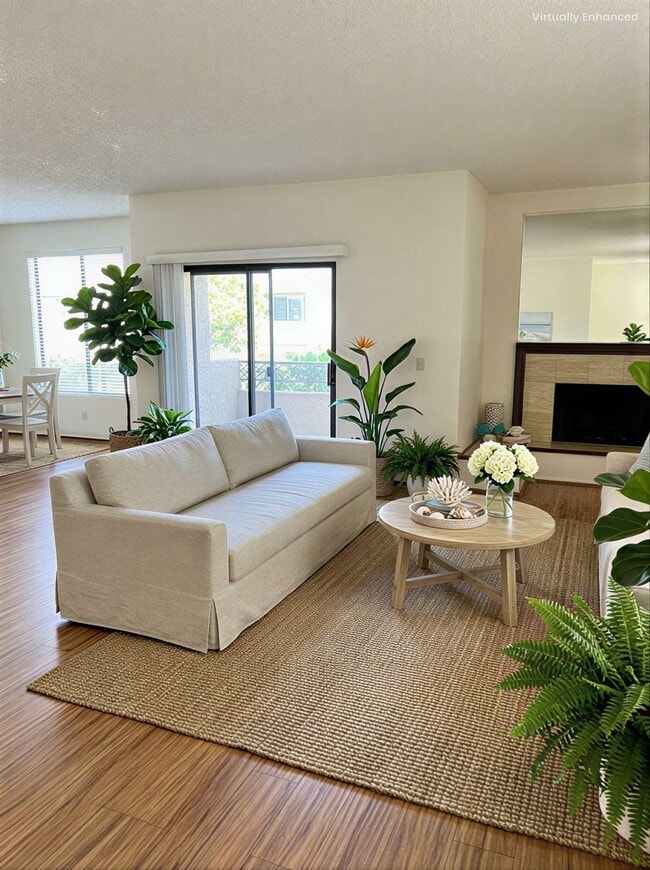 Living Room with Decorative Fireplace & Balcony - 4707 Willis Ave Unit 101