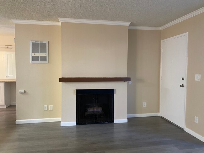 gas fireplace and front door - Bay Timbers Apartments