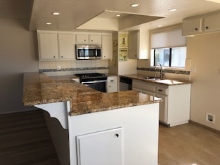 Kitchen with stainless steel dishwasher, oven, microwave - 533 N Helberta Ave