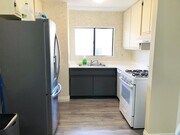 Kitchen with hand-stenciled walls. - 620 E Harvard Rd Condo Unit G