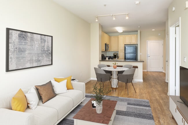 Kitchen, living, and dining areas with hard surface flooring throughout - Avalon Warner Place
