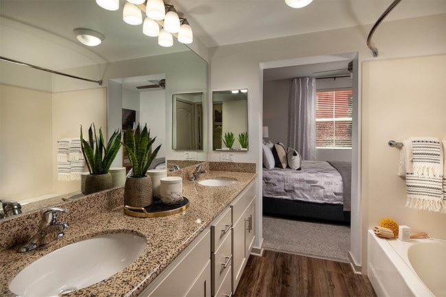 Bathrooms feature soaking bathtubs, granite countertops and luxury vinyl plank flooring - Mira Bella Apartments