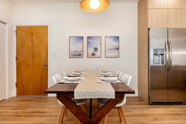 Inviting dining area with seating for four and warm pendant lighting - 2221 Ocean Ave Unit 202