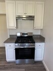Gas range and oven in a smartly organized kitchen. - 5027 2nd Ave Apartment Unit 5027 2nd Ave