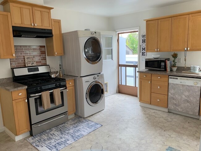 Kitchen equipped with washer, dryer, stove, dishwasher, and refrigerator - 4092 Howard Ave