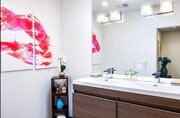 Bathroom with double vanity sink - The Runyon Apartments
