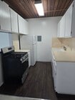 Kitchen. new paint,Tiled counter, refrigerator, vinyl plank flooring - 1616 Esplanade Apartments