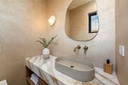 Elegant powder room with custom vanity, plaster walls, and a modern wall-hung toilet - 836 Waterloo St House