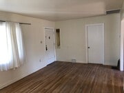 Living room looking toward front door on left, 2nd BR door on right. - 10516 Blythe Ave