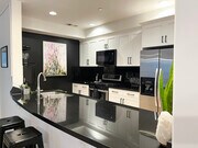 very large kitchen with granite countertops, gas stove, stainless steel appliances - 5037 Rosewood Ave Unit 101