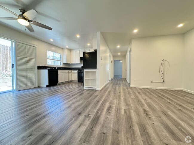 Large living room with recessed lighting, plantation shutters opening to private garden patio. Upgra - 1757 17th St Unit #3 Rental