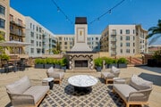 Outdoor fireplace with comfortable lounge area - Terraces at Paseo Colorado Apartments