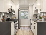 Tiled kitchen with stainless steel microwave, oven, fridge, and fixtures. - The Glendon Building Apartments