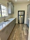 Fully remodeled kitchen with brand-new appliances and modern finishes. - 4043 1/2 W 21st St Unit 4043  half
