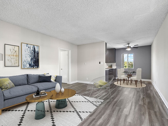 Spacious hardwood floor living room with view of dining area. - Woodbridge Park