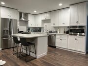 Full-size open kitchen with premium stainless appliances and quartz counters and island. - 1755 Mission Cliff Dr Unit 1753