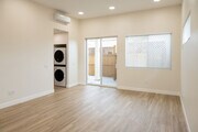 view of living space, door to private patio and hallway to left - 4772 Bancroft St Townhome
