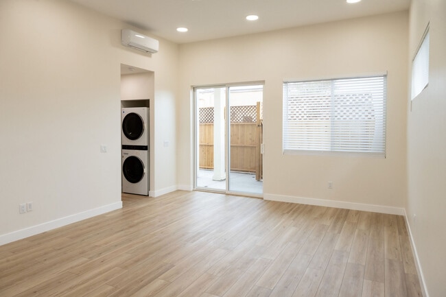 view of living space, door to private patio and hallway to left - 4772 Bancroft St