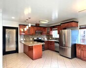 Kitchen from main entrance showing doored entrance to living area. - 2330 S Mansfield Ave