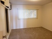 Bedroom with large window, ceiling fan, vinyl plant floor - 1616 Esplanade Unit #