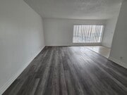 Living room with Luxury Vinyl Plank - 3455 Elm Ave Unit #307