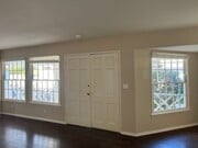 Living room with light filled windows overlooking the front porch and new landscaping - 467 S Bentley Ave