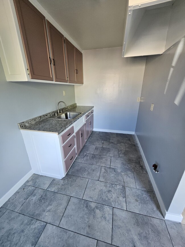 Space for small table for two and small stove/fridge. - 2561 Olive St Unit Upstairs Room