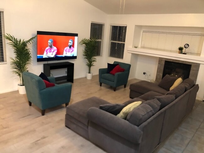 Living room with 75" flat screen TV for kicking back and watching your favorite streaming shows and - 15860 Alisa Viejo Ct Unit House