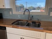 Beautifully sealed butcher block counter tops and 2-tub kitchen sink with disposal. North facing window. - 4470 Swift Ave Apartment Unit ADU