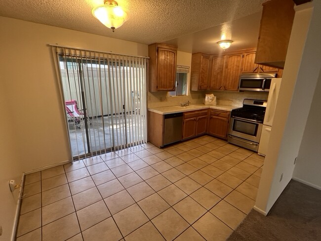 well quipped kitchen with view of patio - 3262 Montrose Ave Unit A
